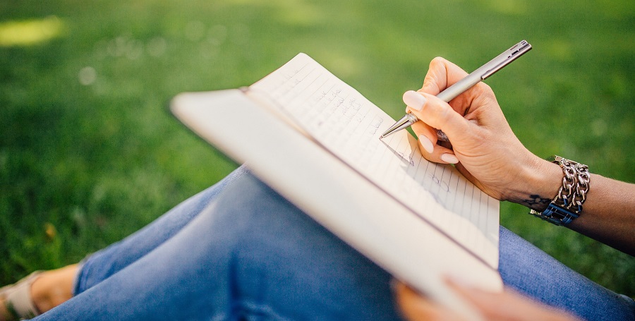 Person wrinting in notebook