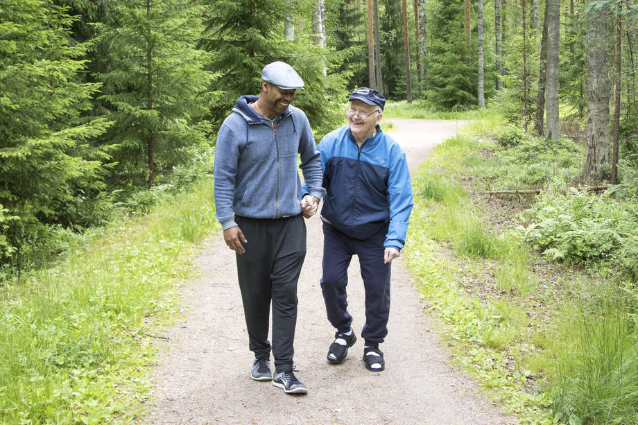 Two men walk in the walkway.