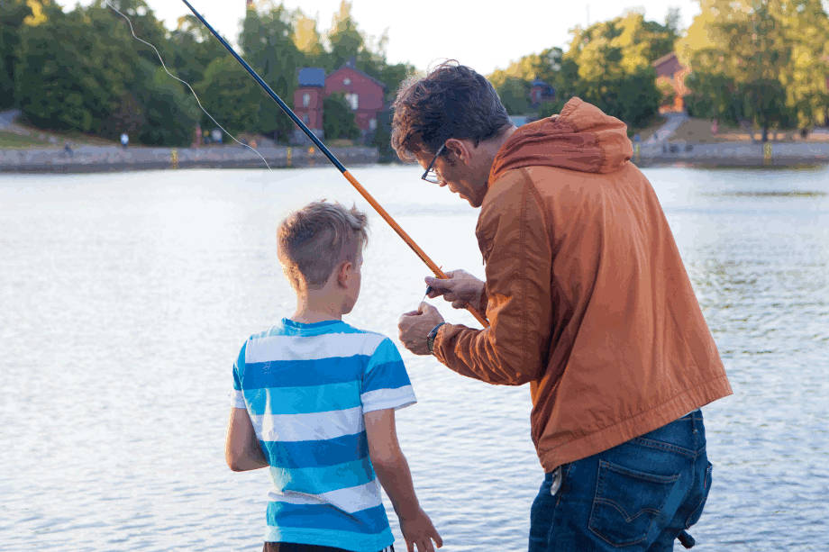 Father and son hooking a worm.