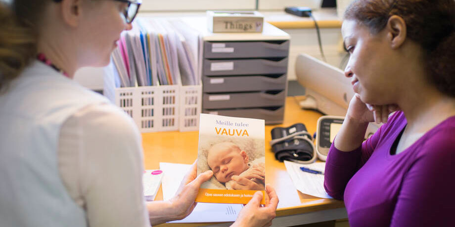 En blivande mamma med hälsovårdaren på mödrarådgivning.