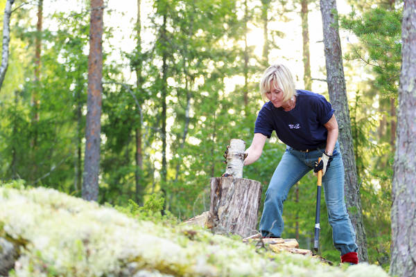 Woman chopping wood.