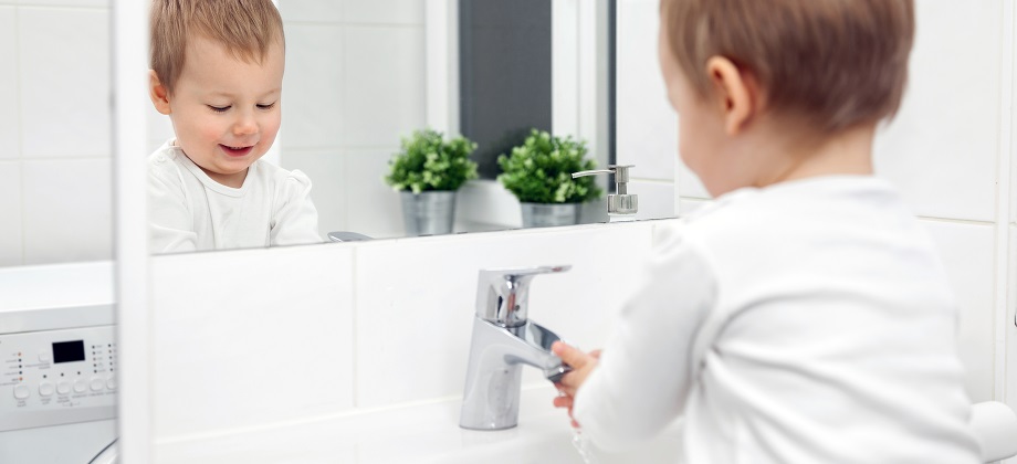 Child washes hands.