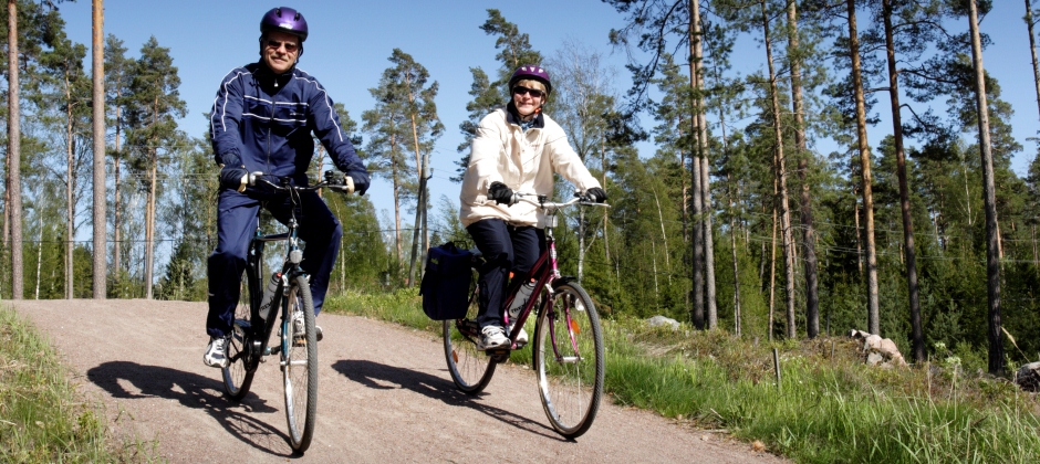 A couple cycling on a country road.