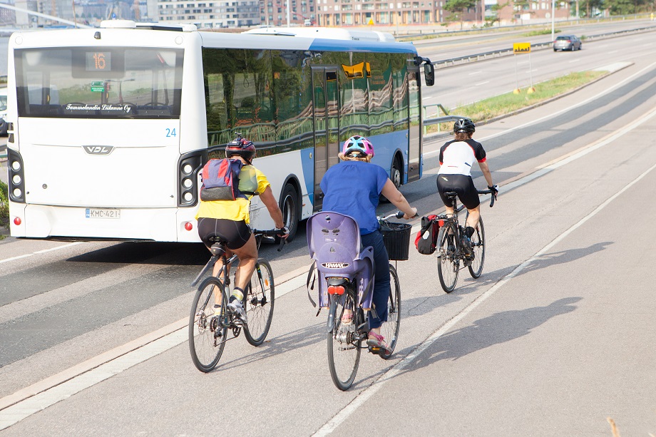 Three people cycling on a pathway.