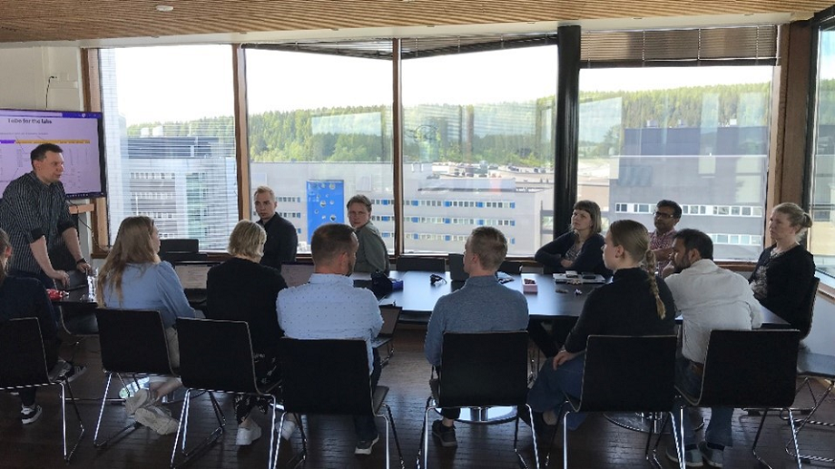 Group photo, people sitting around the table.