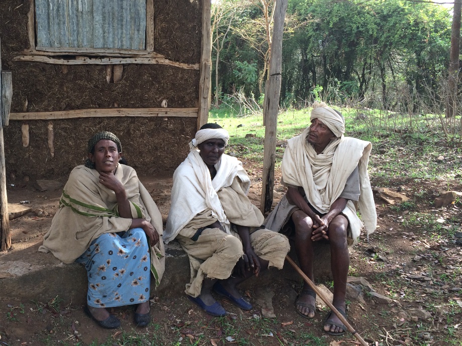 Three persons sitting and discussing in Amhara, Ethiopia.