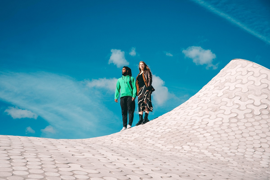 Two people are standing and looking at the sky.
